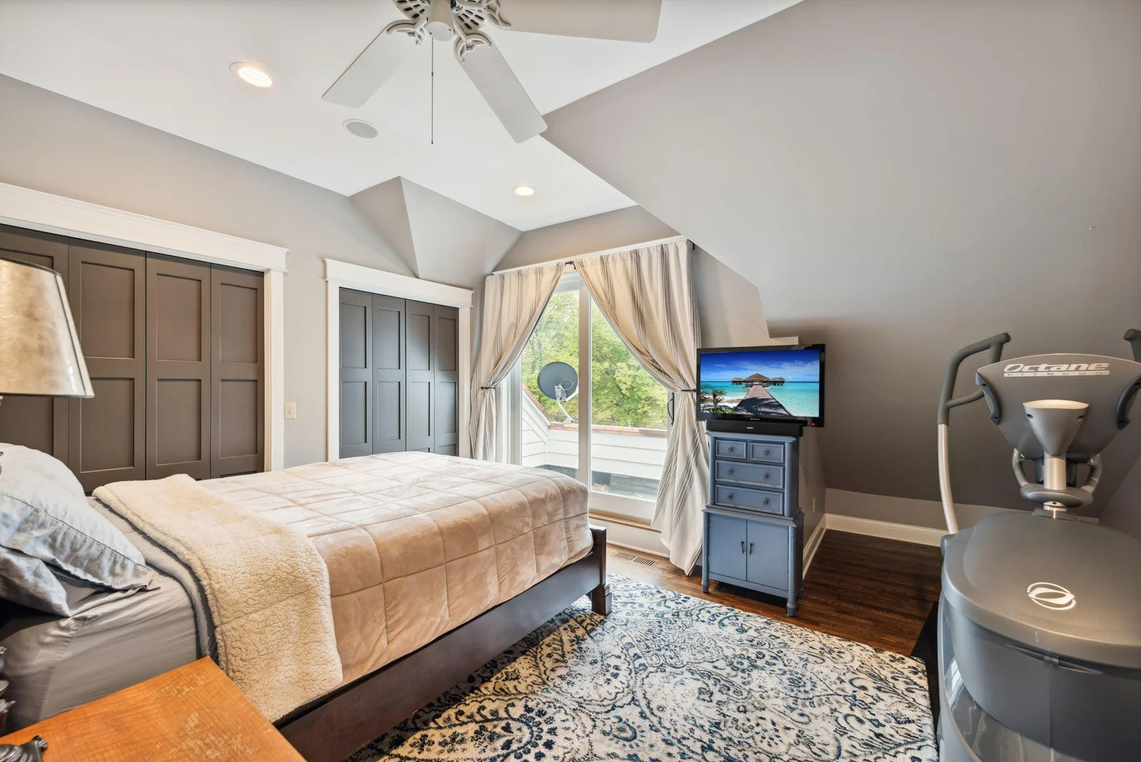 This fourth upper-level bedroom features hardwood floors, ample closet space, and its own private balcony.