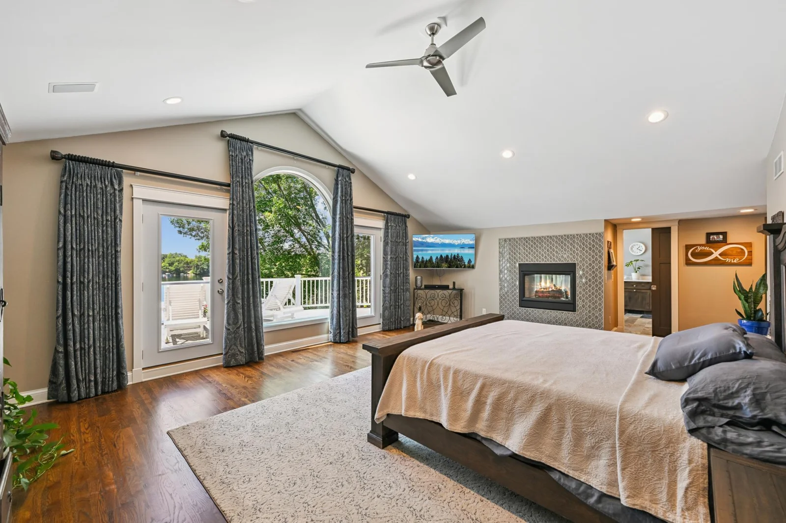 This one-of-a-kind owner’s suite features stunning lake views, a cozy two-sided gas fireplace, and a spacious walk-through closet with ample storage for every season Minnesota brings.