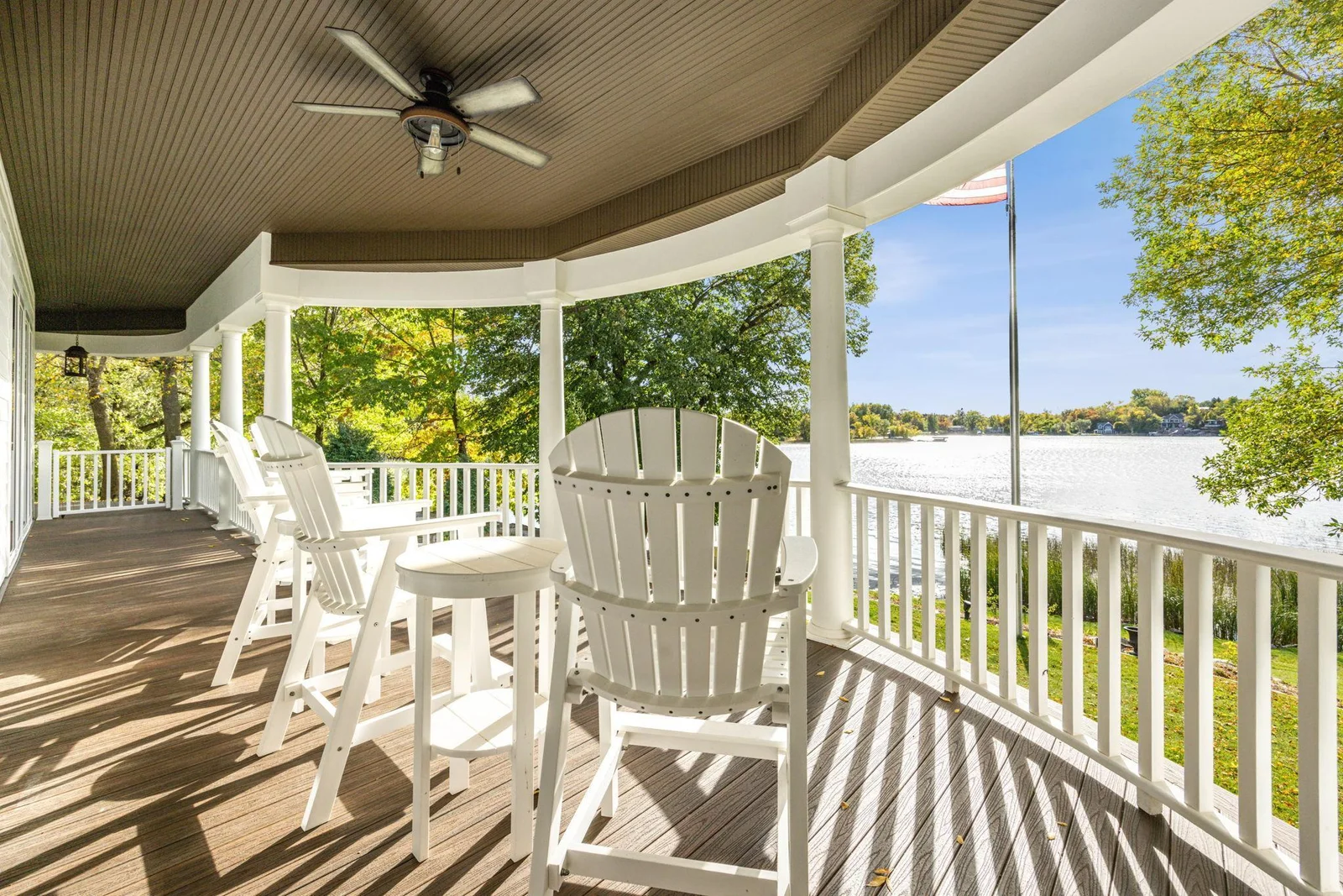 Relax and unwind on the expansive covered porch, offering panoramic lake views, cooling ceiling fans, and the perfect spot to enjoy sunrise coffee or sunset cocktails on West Lake Sylvia.