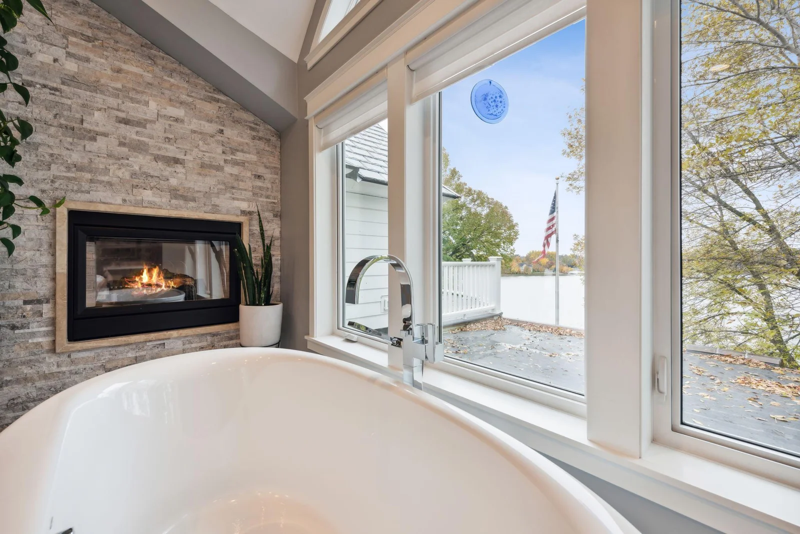 Soak in serenity with lake views and a cozy fireplace, this spa-like bathroom offers the perfect place to relax and unwind in comfort and style as you overlook Totem Pole Bay.