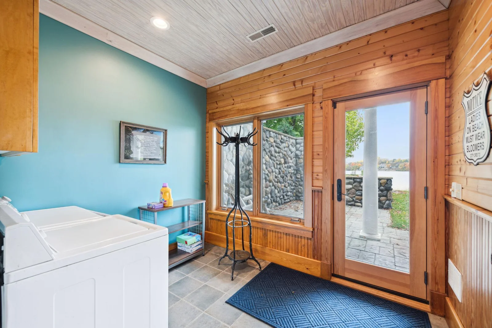 Convenient lakeside entry features laundry just steps from the sauna. Ideal for handling towels and swimsuits after a fun day on the water.