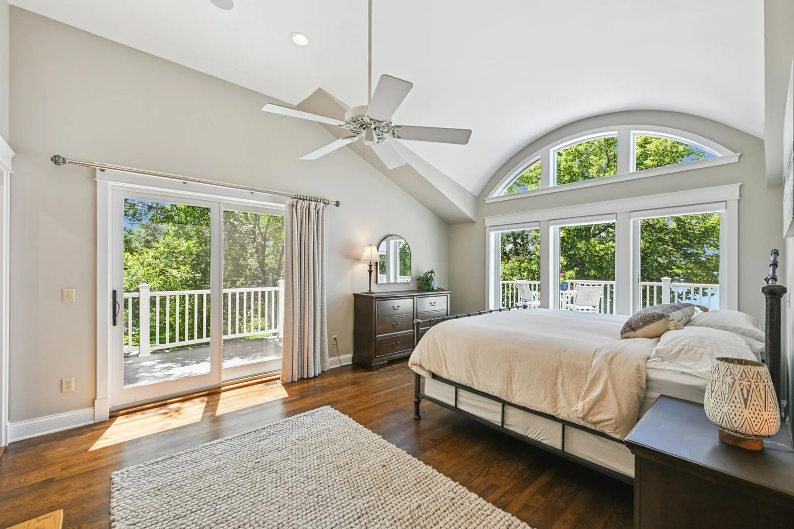 One of four upper-level bedrooms, this sun-filled suite offers a walk-in closet, private bath, and its own balcony that wraps around to the lakeside deck. Are you ready for your morning coffee with a view?