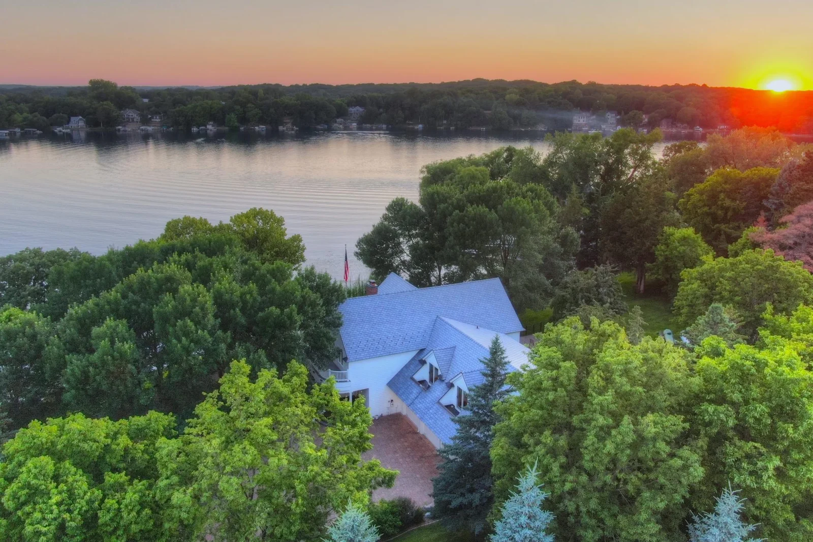 This Southwest facing shoreline offers panoramic evening views as the sun dips below the tree line, casting golden reflections across the water an idyllic backdrop for peaceful lakeside living less than an hour from the Twin Cities.