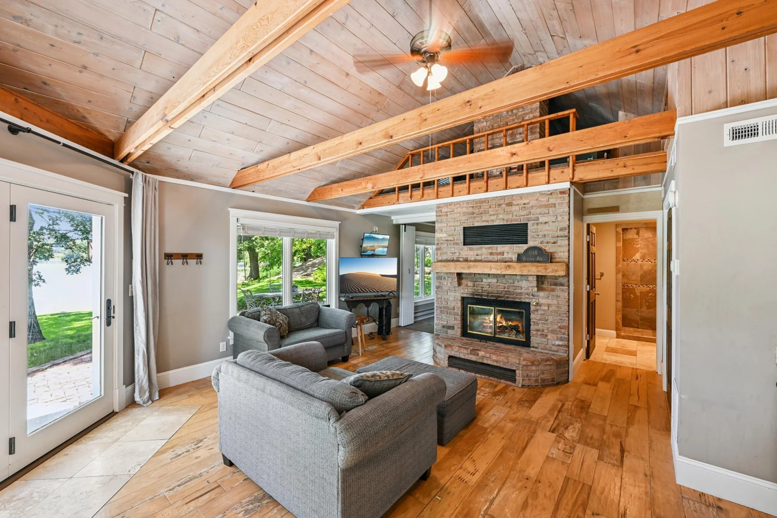 Beautifully finished guest house featuring vaulted wood-beamed ceilings, a cozy brick wood burning fireplace, and lake views from every window. A private loft creates a welcoming retreat for guests in this one-of-a-kind lakeshore estate.
