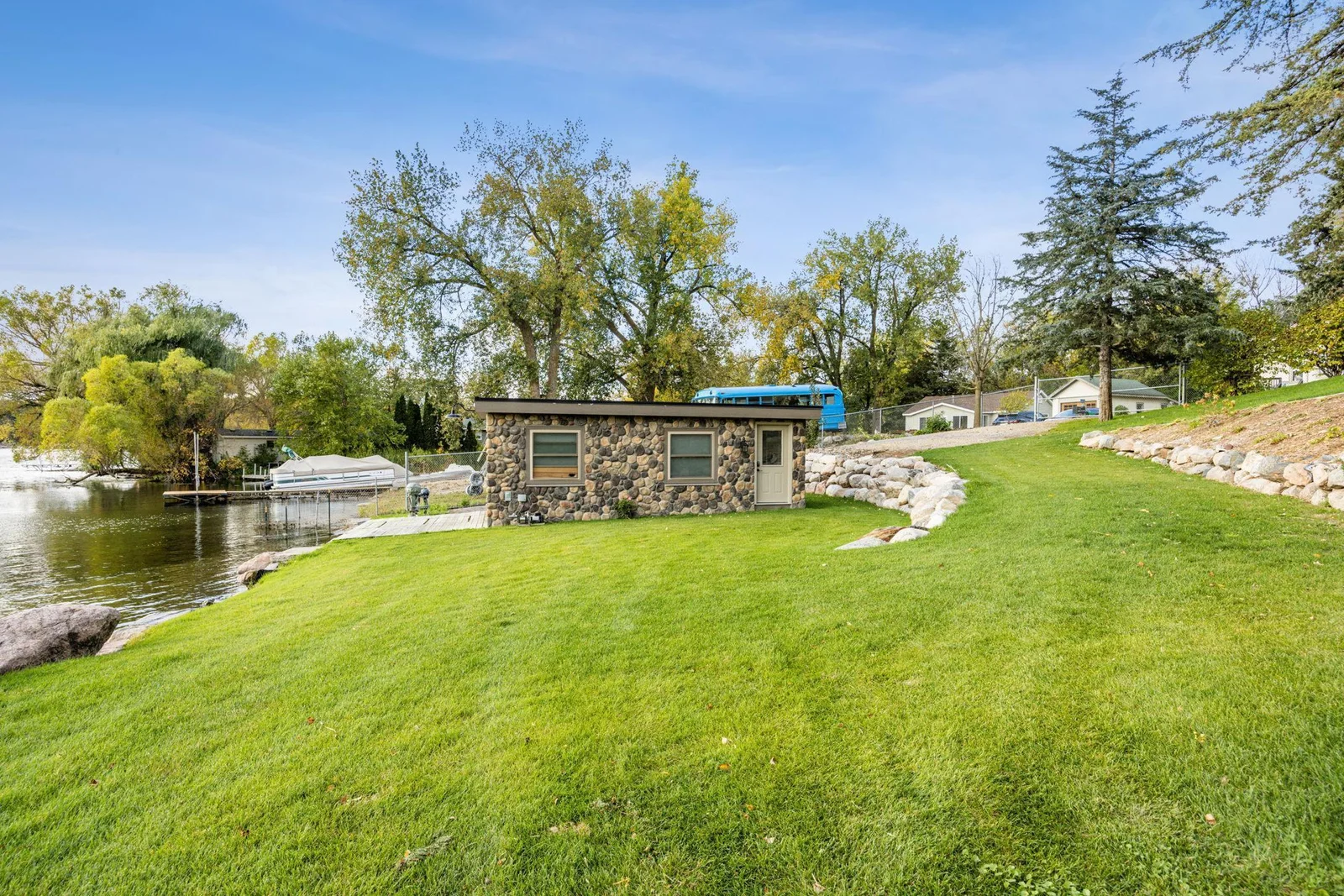 Built in 2019 the boathouse offers convenient storage for lake gear just steps from the shoreline with easy access to the dock, this structure enhances the functionality and appeal of this exceptional property.