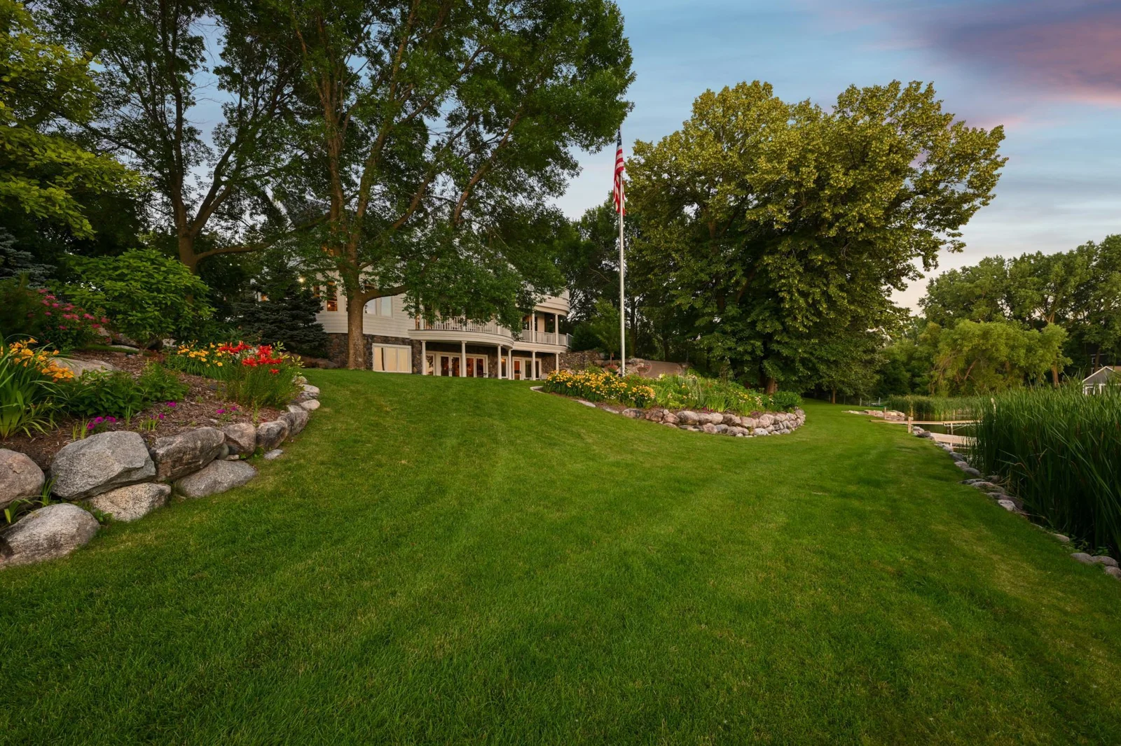 The gently sloping lawn offers stair-free access to both beach areas, making it easy to walk or drive a golf cart across the beautifully landscaped lakefront.