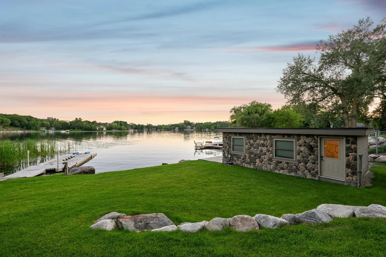 Located on the west side of the property, the 2019-built stone boathouse offers the perfect space for lakeside entertaining or convenient storage just steps from the water.
