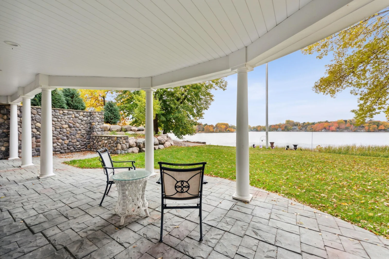 Enjoy serene lakeside living from this expansive covered patio, offering panoramic views of Lake Sylvia and a peaceful natural setting just outside the walkout lower level.