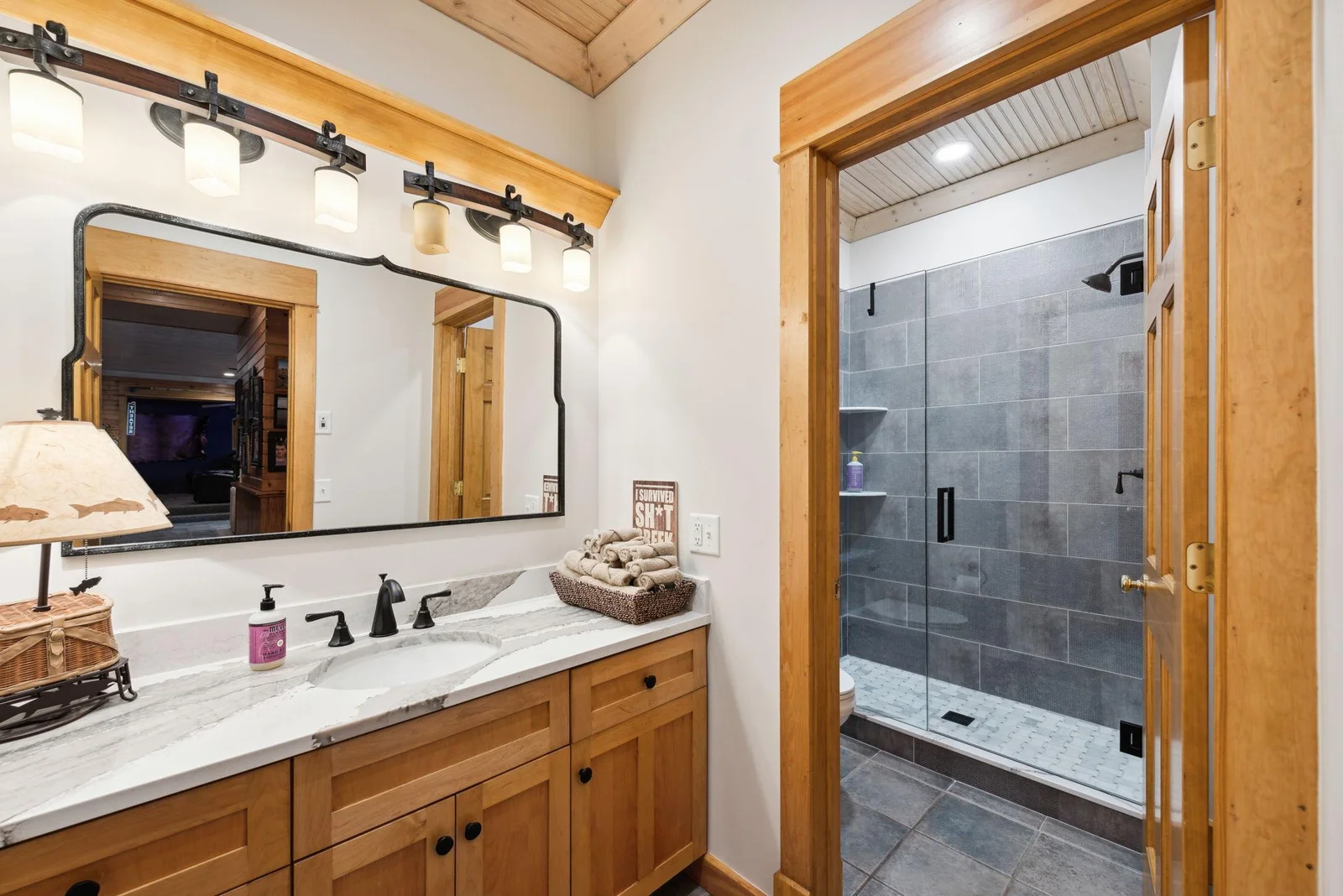Remodeled in 2023, the lower-level ¾ bath features a spacious tile walk-in shower, separate toilet room, and updated finishes throughout.