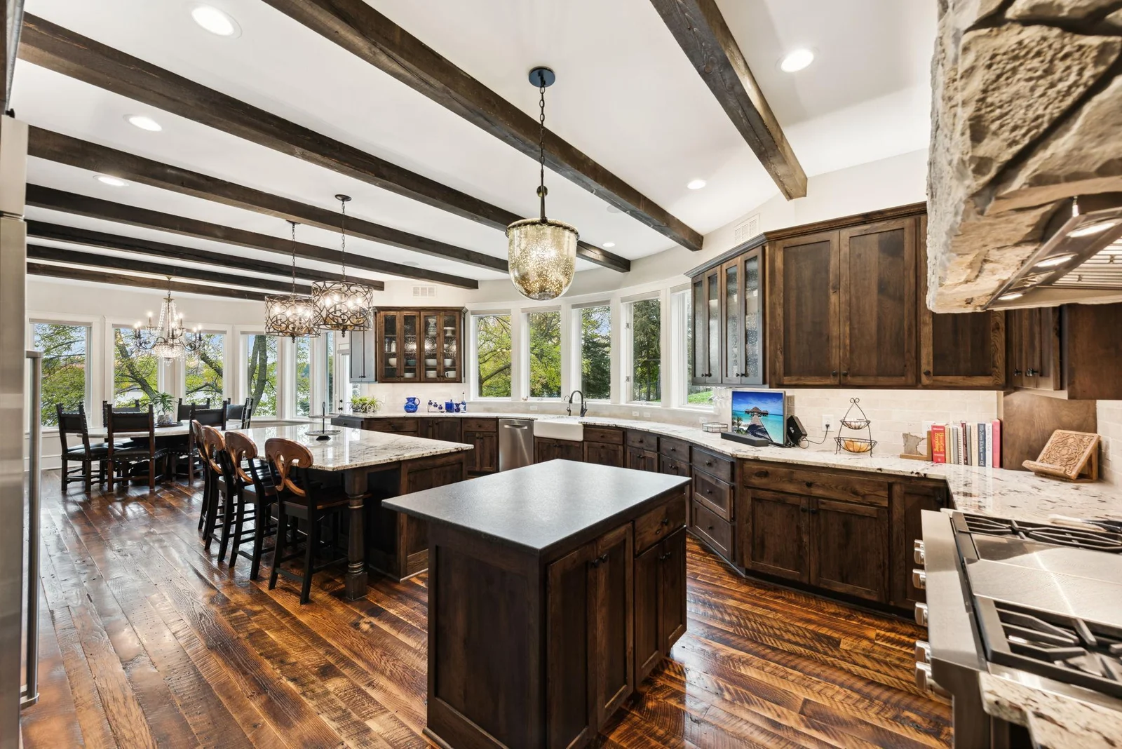 This stunning 2019 kitchen remodel features custom cabinetry, high-end countertops, rich hardwood floors, and premium Wolf & Sub-Zero appliances, designed for effortless entertaining and everyday culinary enjoyment.