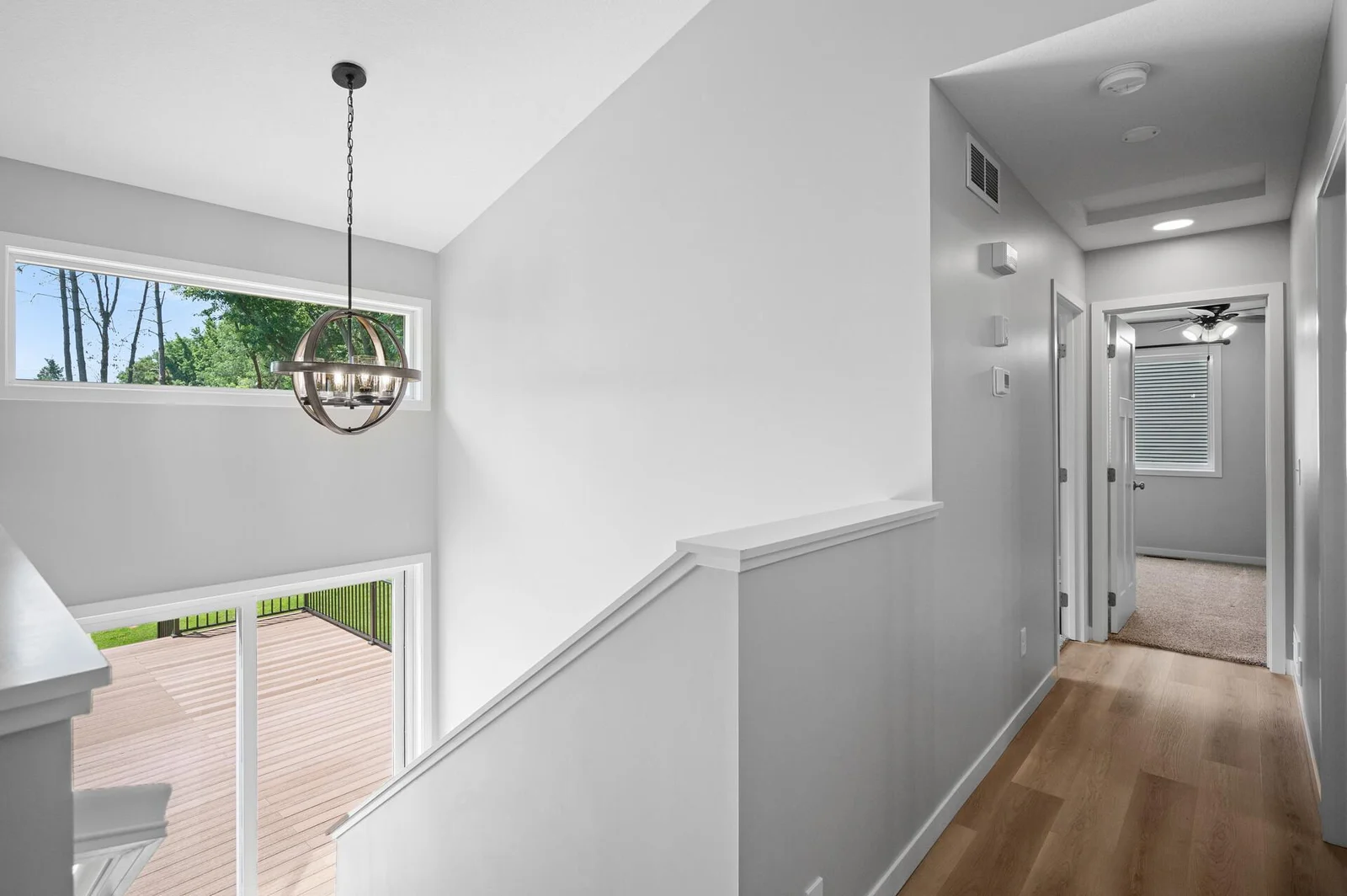 Open rear stairwell offers plenty of natural lighting and walks out to backyard.