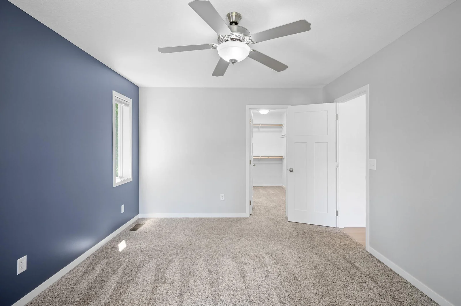 Primary Bedroom with ceiling fan, private bath and walk-in closet.