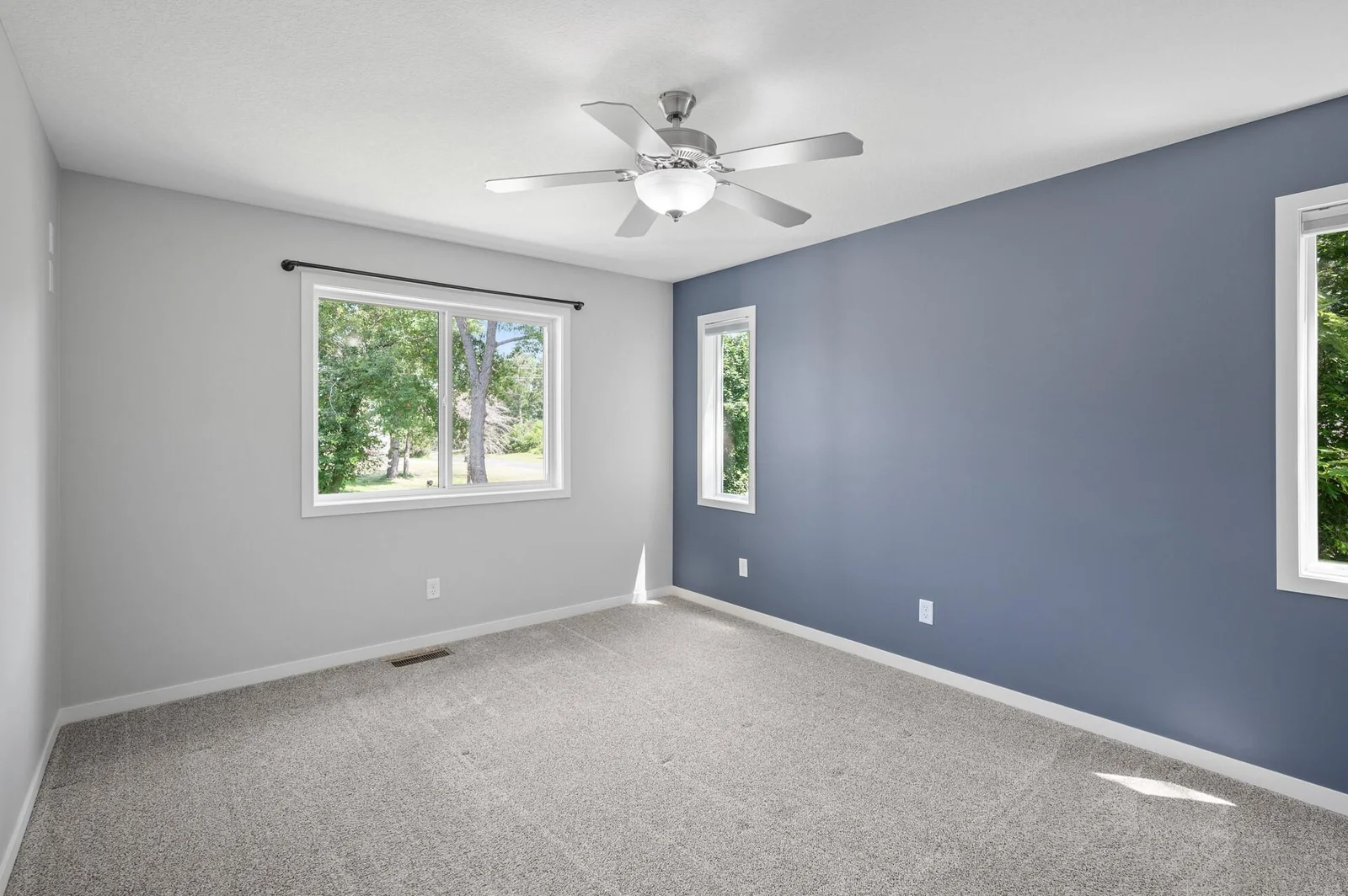 Spacious Primary bedroom with 2 walls of windows.