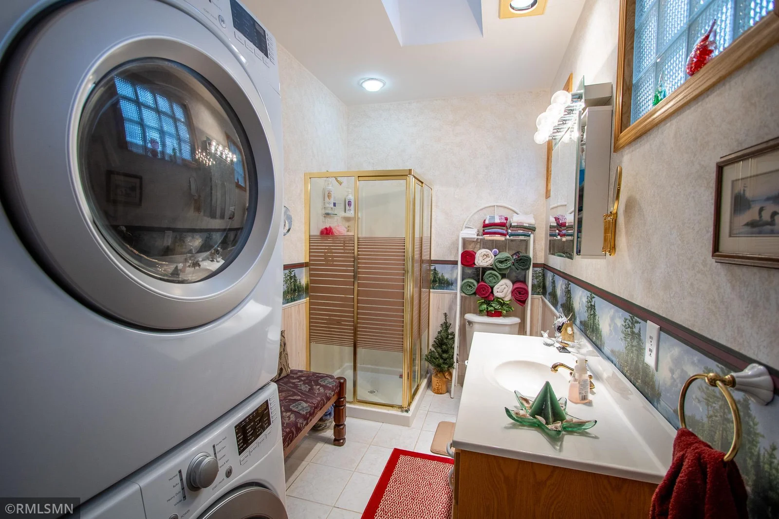 This bathroom also has the laundry facilities.