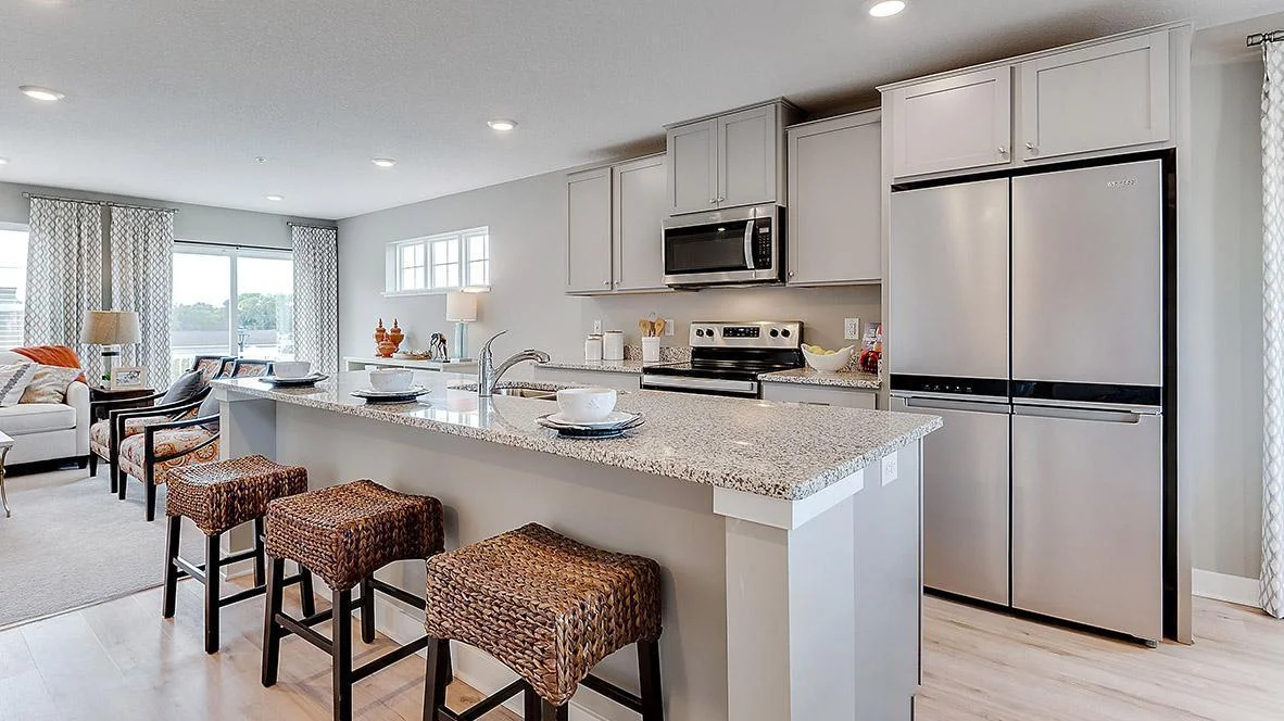 Spacious island with enough seating for 3-4 people. Model picture shown. Colors and finishes may vary. Subject address is an interior unit. Exterior unit photos shown.