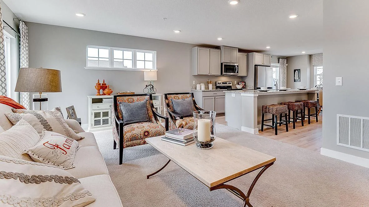 View of the large family room. Model picture shown. Colors and finishes may vary. Subject address is an interior unit. Exterior unit photos shown.