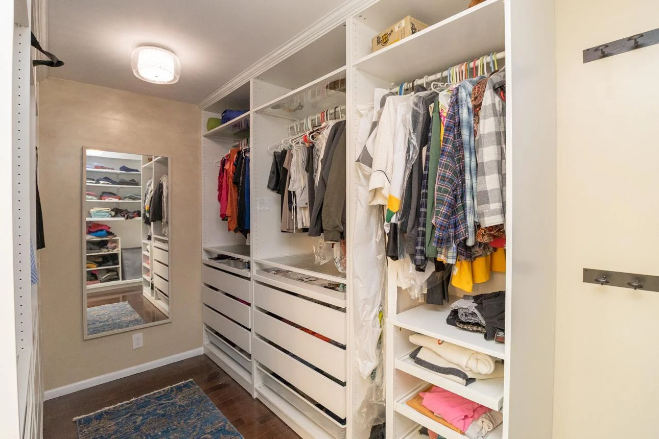Walk in closet with dimmer chandeliers