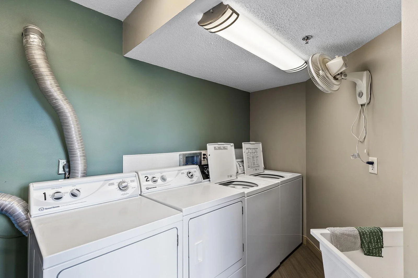 Each floor has a laundry room with 2 washers and dryers located by the elevator.