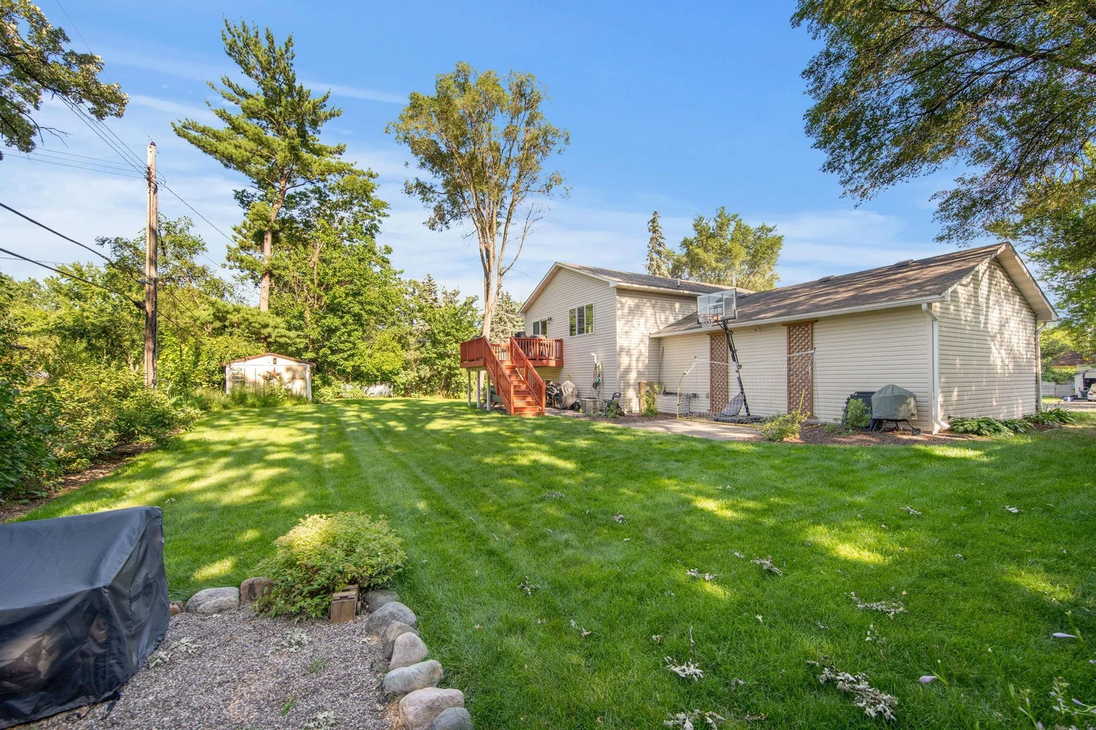 Spacious backyard with deck, firepit area, and patio!