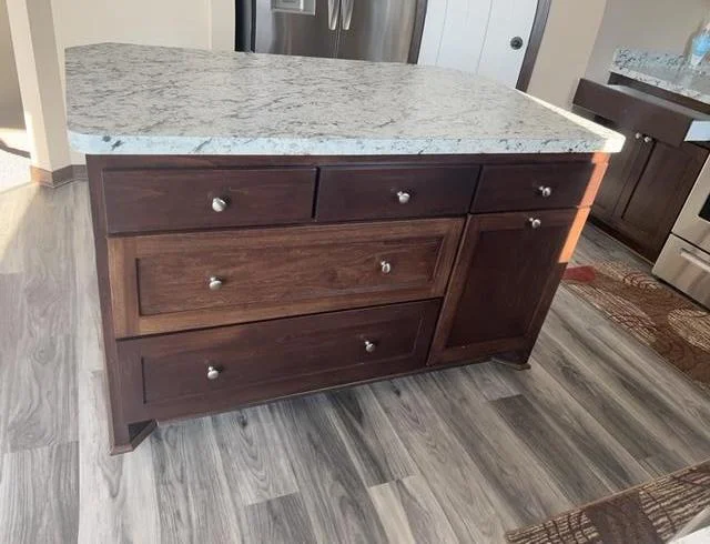 Island with large drawer storage and recycling center.