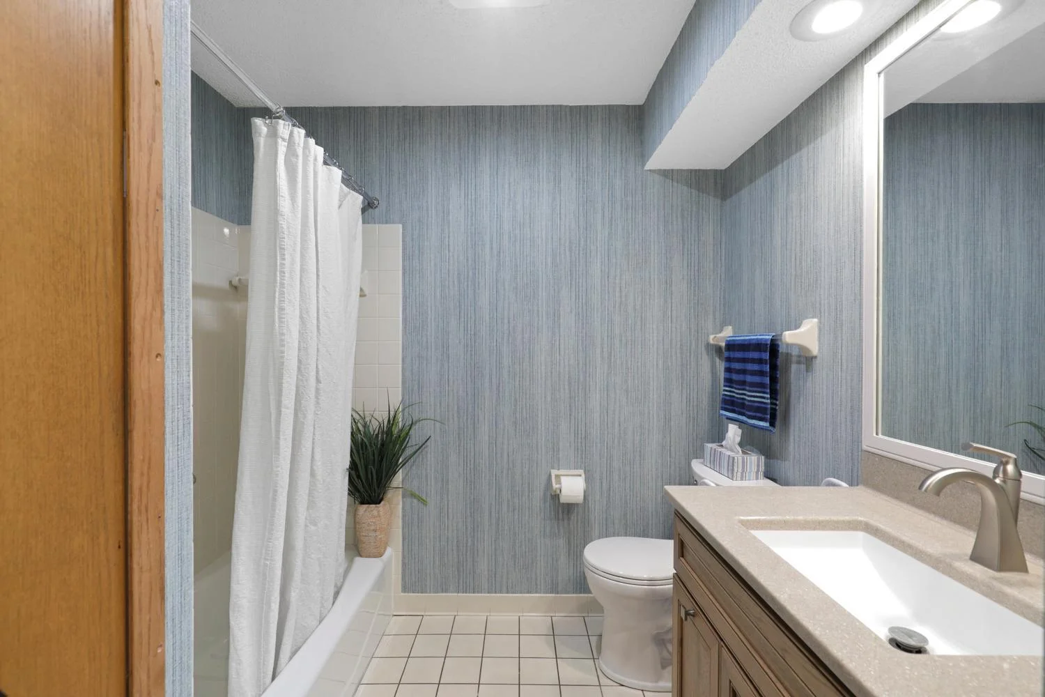 Updated bathroom with stylish wallpaper