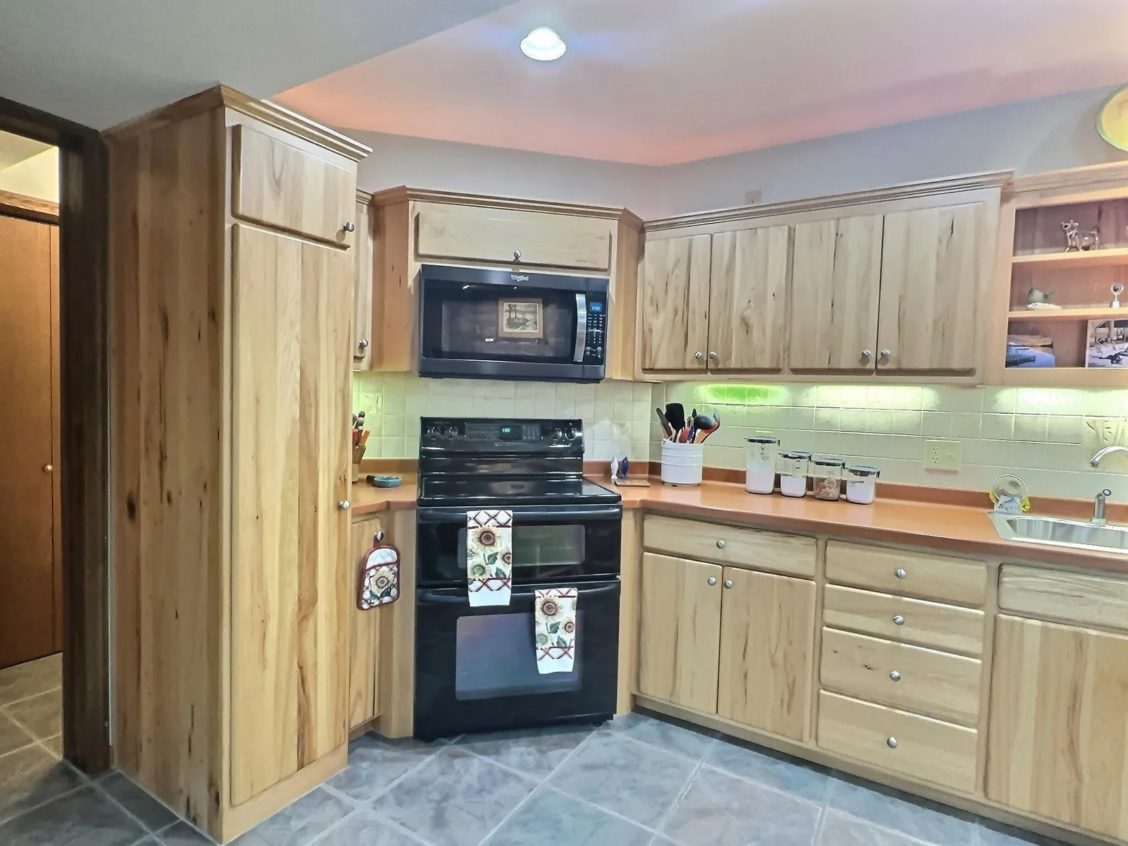 Sleek hickory cabinets span the wall of the kitchen offering plenty of storage space.  The double oven will come in handy when creating special meals for the friends and family coming to enjoy your company and hang out at the lake!