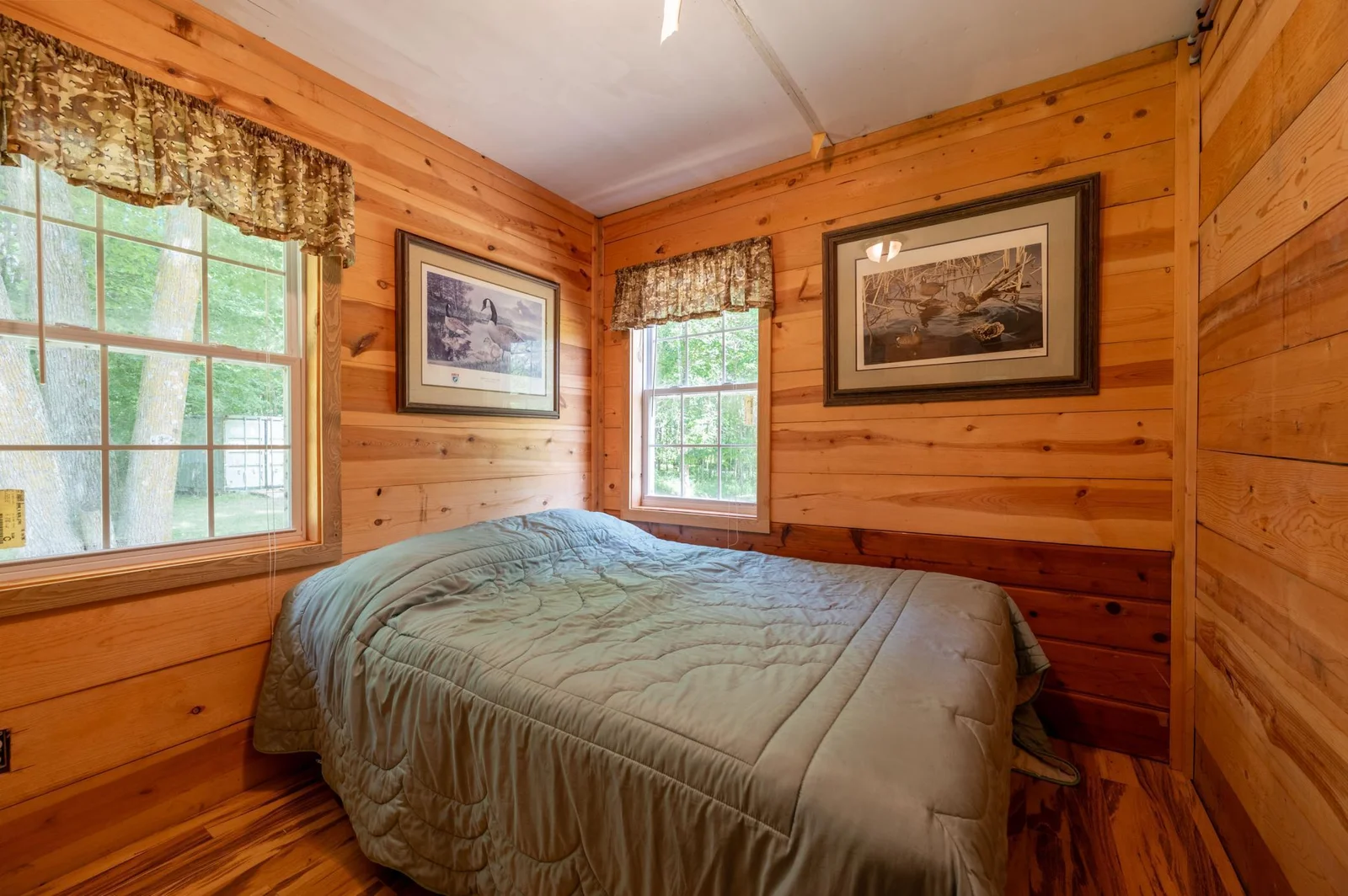Bedroom with plenty of natural light and knotty pine.