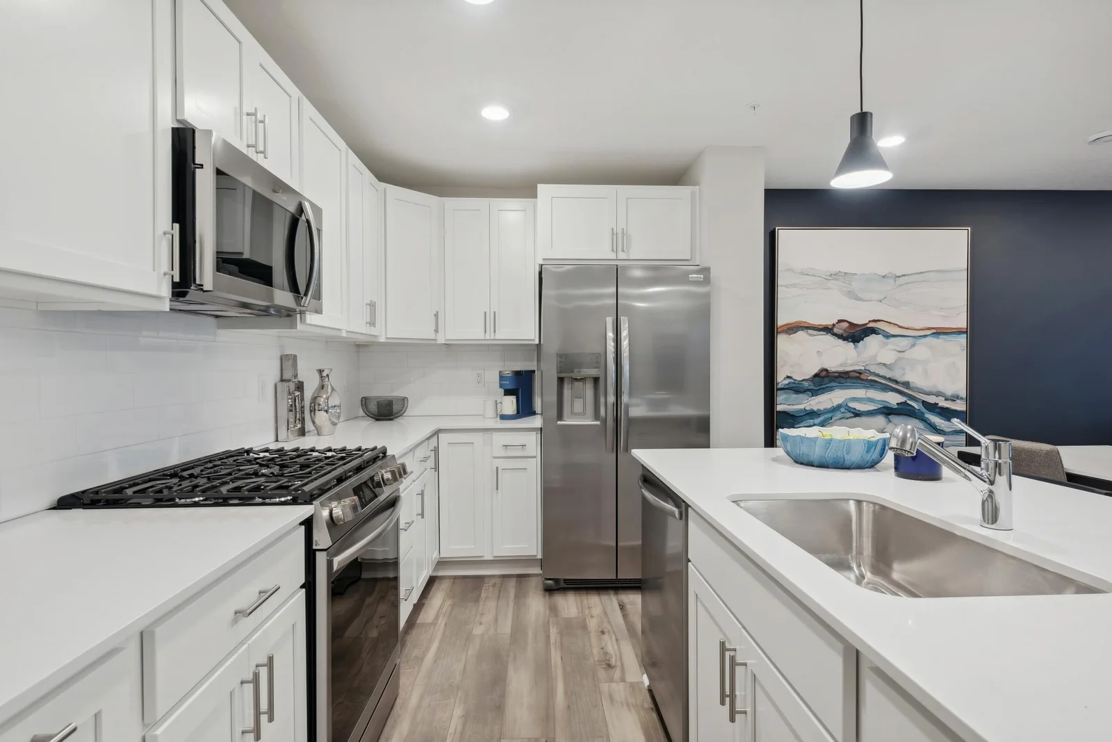 (Photo of decorated model, actual home's finishes may vary slightly) This beautiful kitchen offers a large center island, quartz countertops, and stainless steel appliances!
