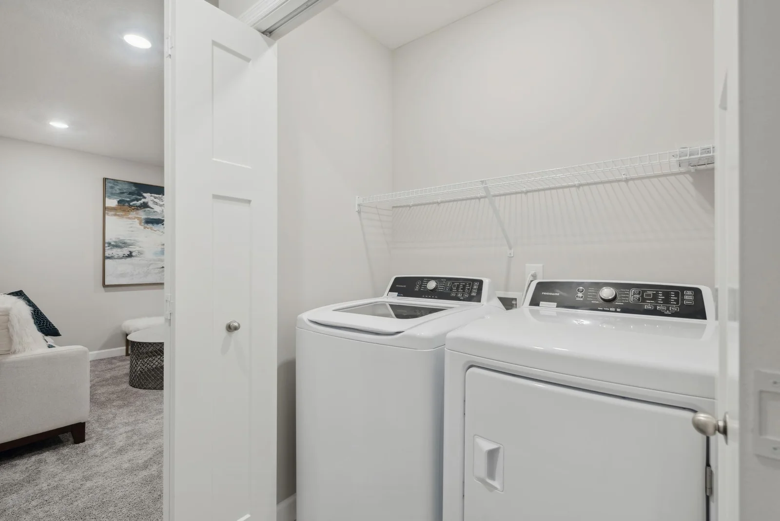 (Photo of decorated model, actual home's finishes may vary slightly) Centrally located on the upper level, along with the three bedrooms, this laundry area is sure to provide the ultimate convenience.