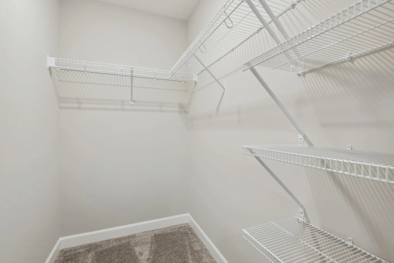 (Photo of decorated model, actual home's finishes may vary slightly) This owner's suite features an incredible walk-in closet.
