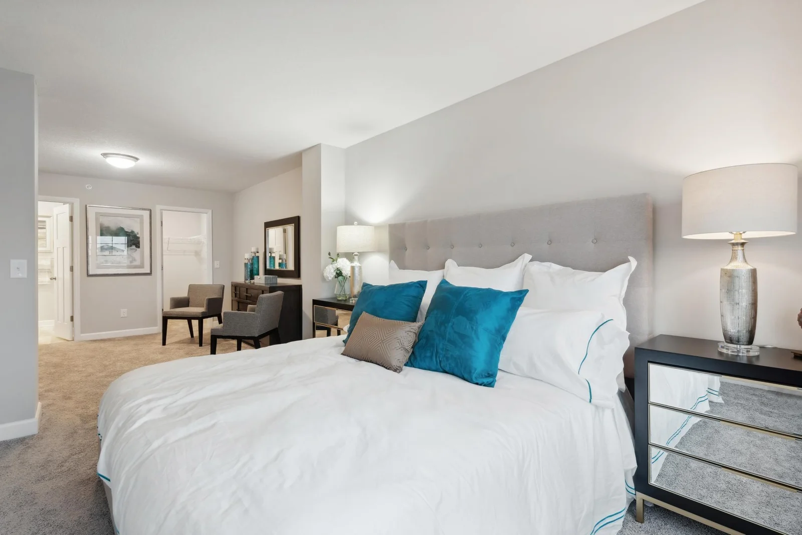 (Photo of decorated model, actual home's finishes may vary slightly) Extremely spacious and elegant, this private owner's suite connects to a large en-suite bath providing a great oasis to relax.