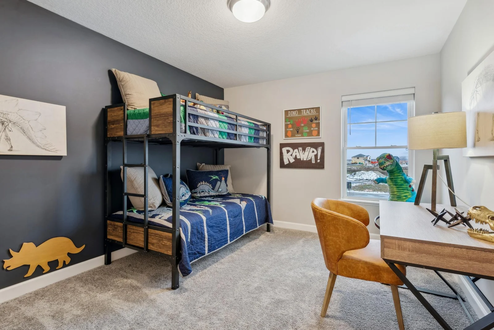 (Photo of decorated model, actual home's finishes may vary slightly) One of two generously sized secondary bedrooms with a spacious closet.
