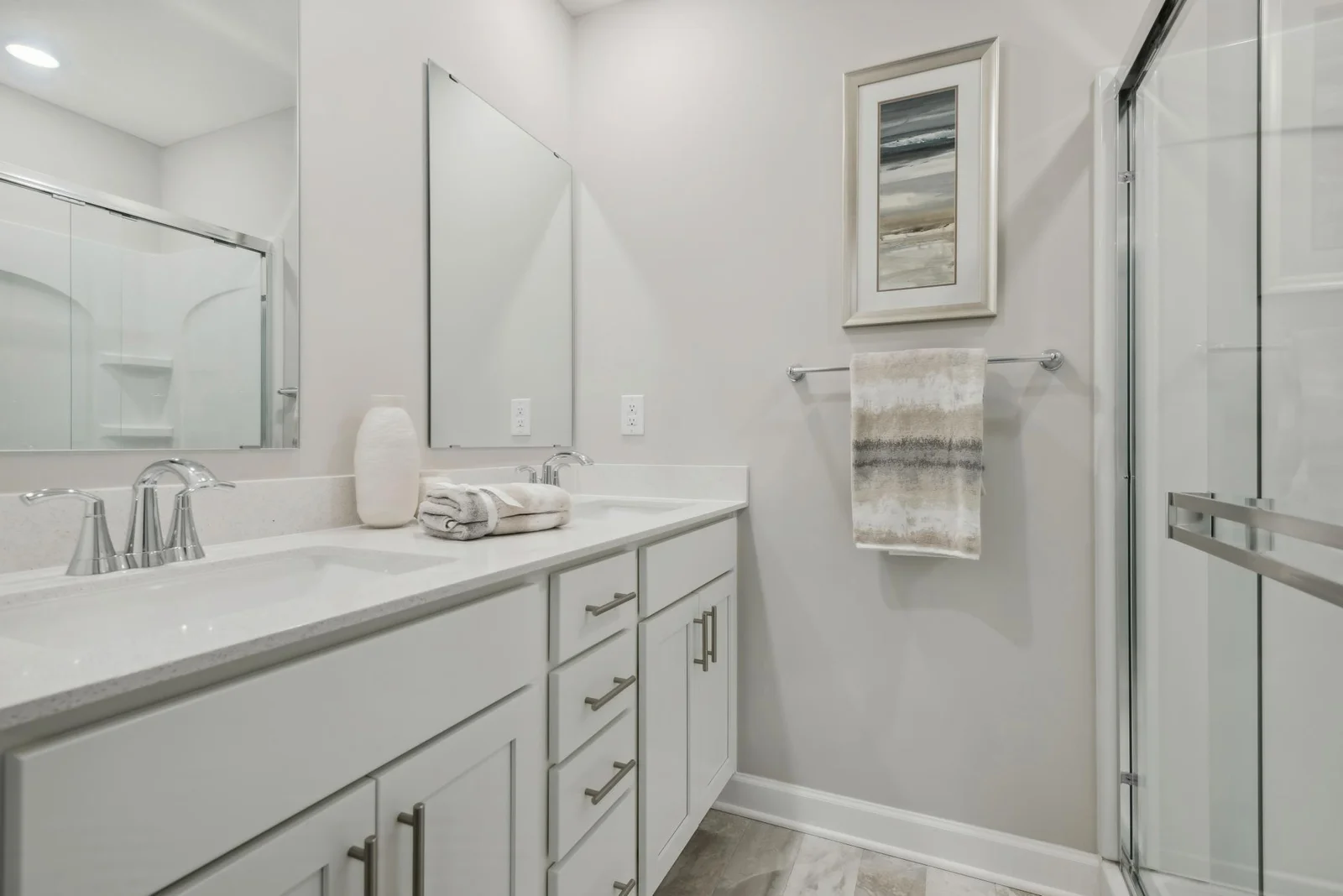 (Photo of decorated model, actual home's finishes may vary slightly) An extension of the owner's suite, this private and spacious bath contains a double-vanity and a large shower.