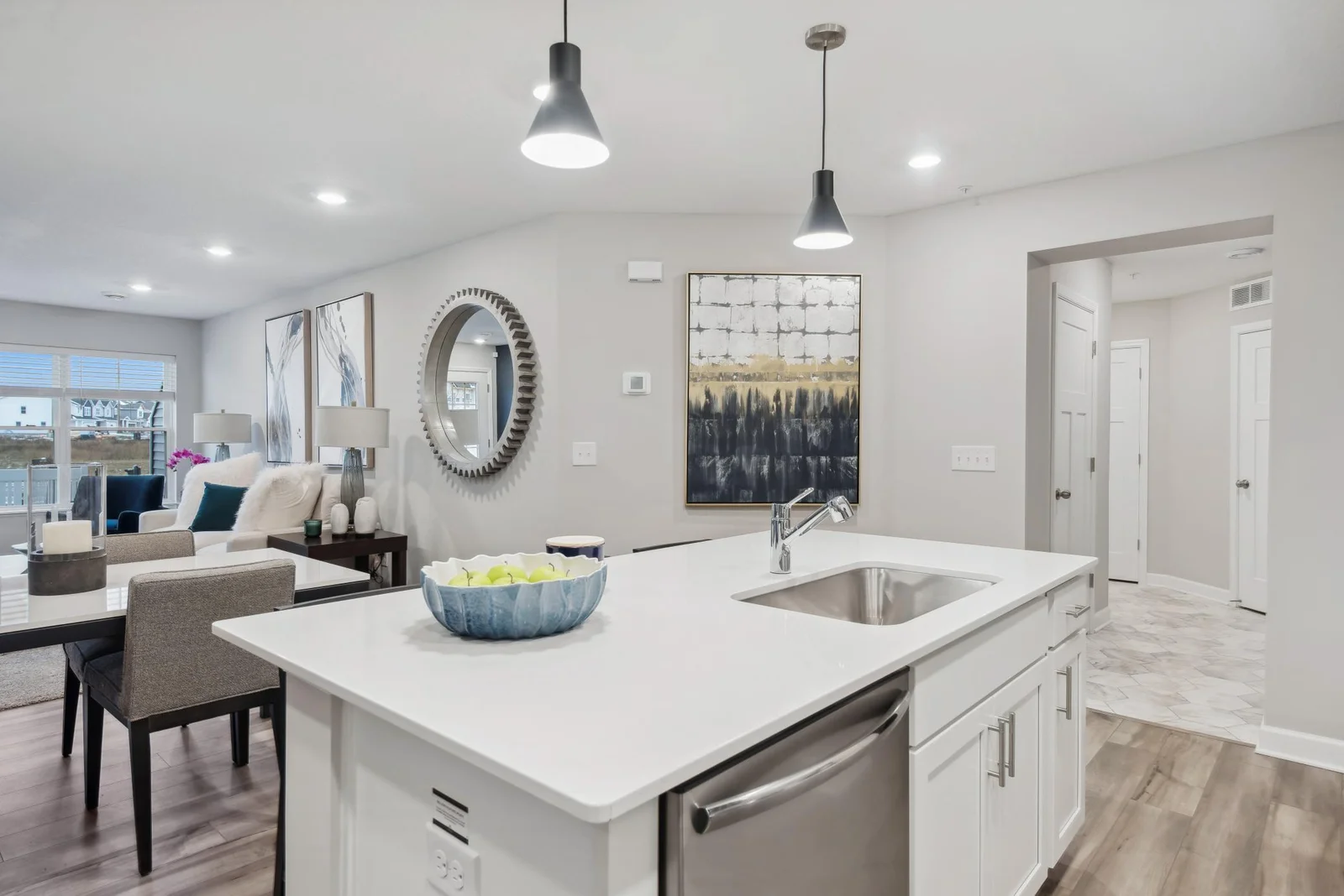 (Photo of decorated model, actual home's finishes may vary slightly) Just off the kitchen there is a separate hallway that leads to the two car garage and a conveniently located half bath.
