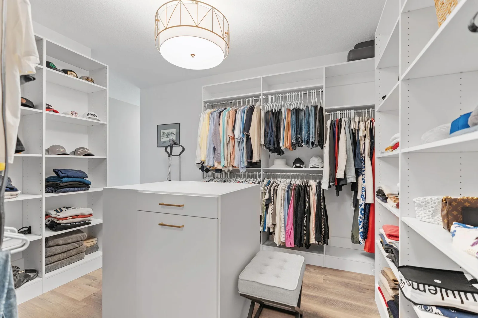 Generously sized Master walk-in closet features professionally installed organizer and center island