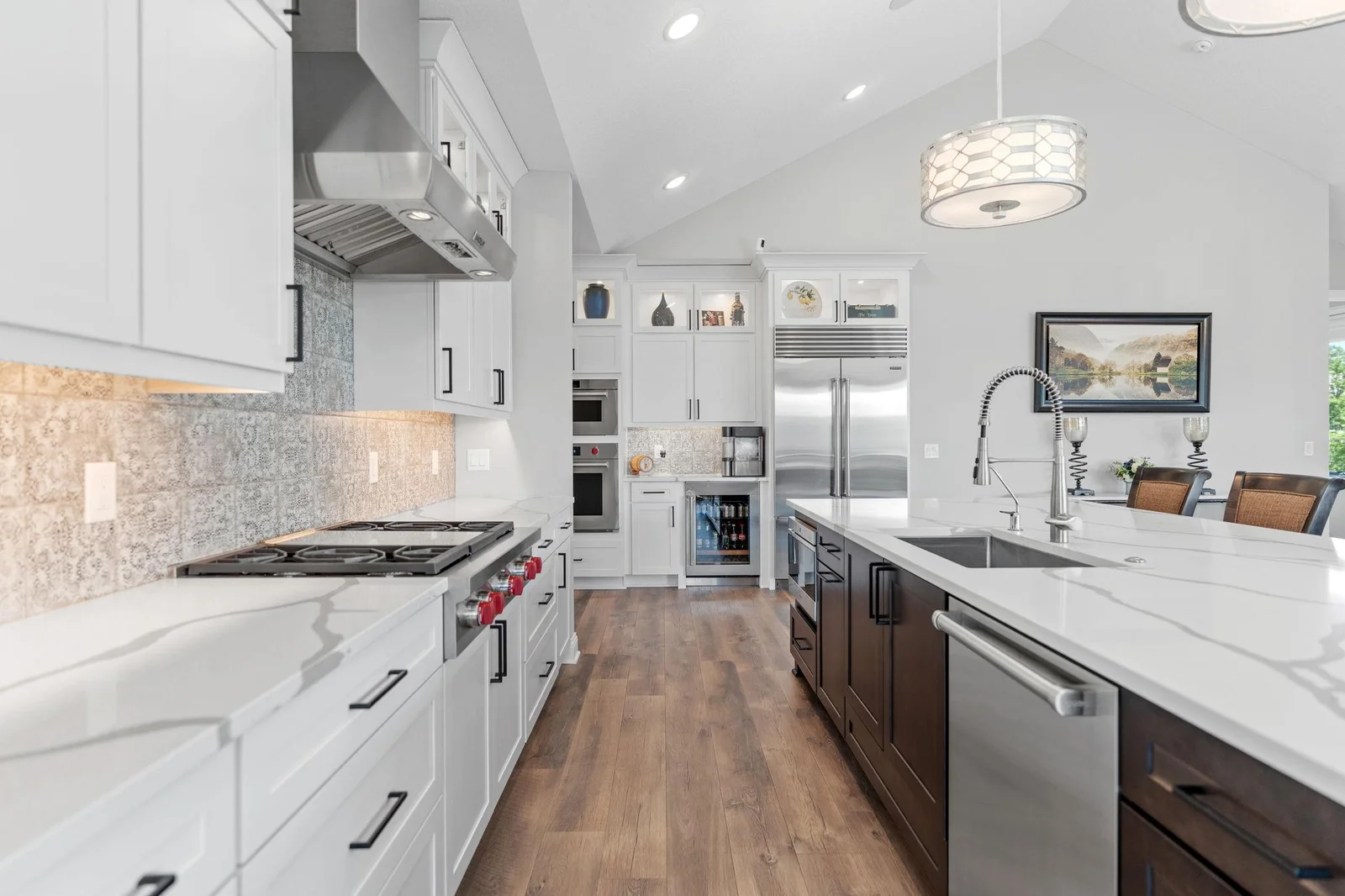 High-end stainless steel appliances include a Sub Zero french door refrigerator, Wolf 36” gas cooktop w/ decorative hood, Wolf dual wall ovens, Wolf built-in convection microwave, Cove dishwasher and Sub Zero beverage refrigerator