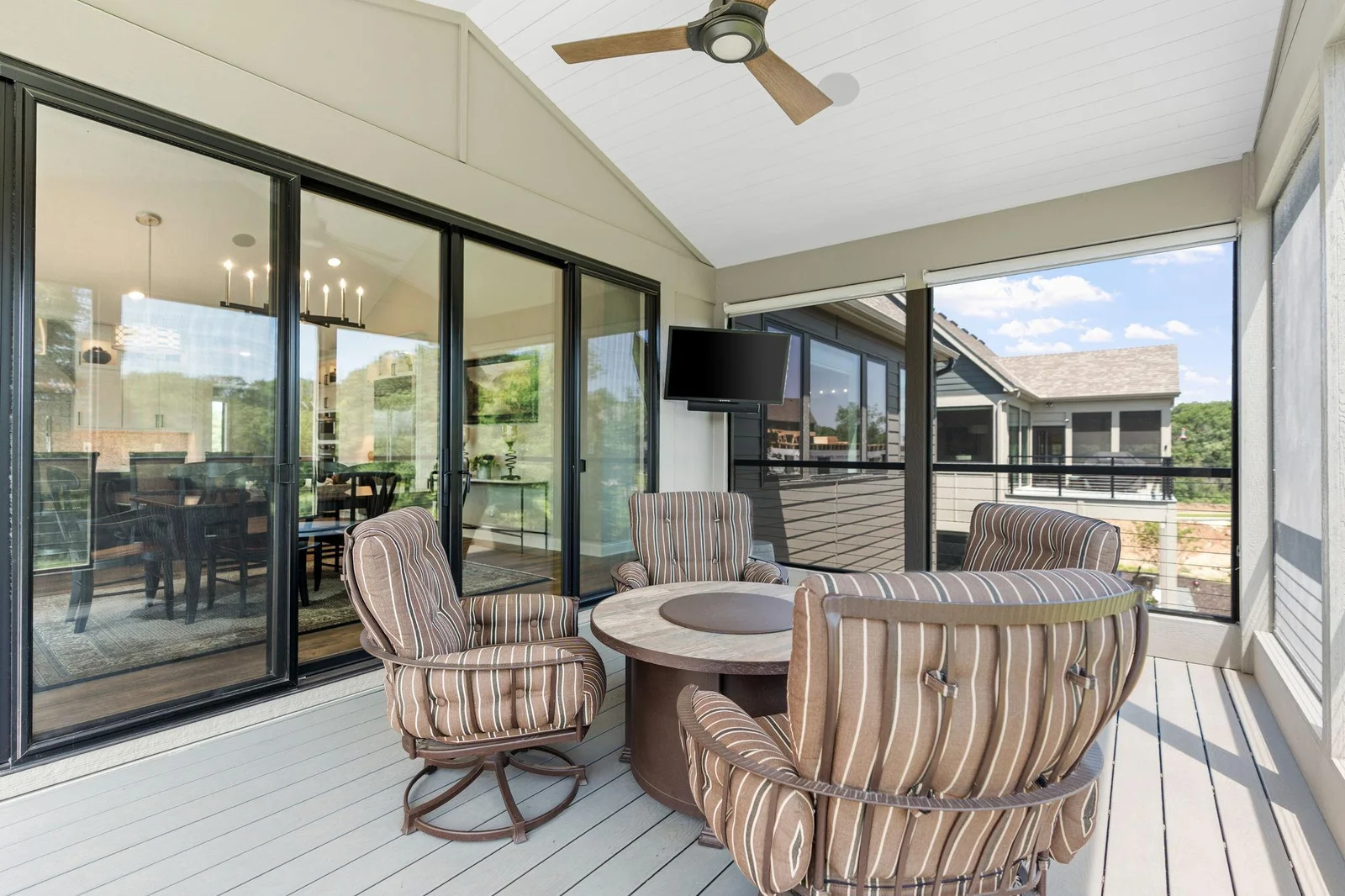 Screened-In Porch features maintenance free decking and cable railings. Access to the deck and shiplap paneled vaulted ceilings