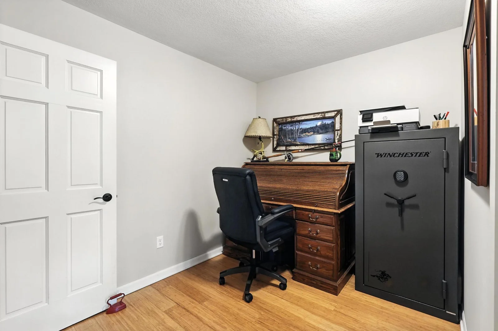 Versatile flex space with gleaming wood flooring and neutral walls, perfect for a home office or hobby room.