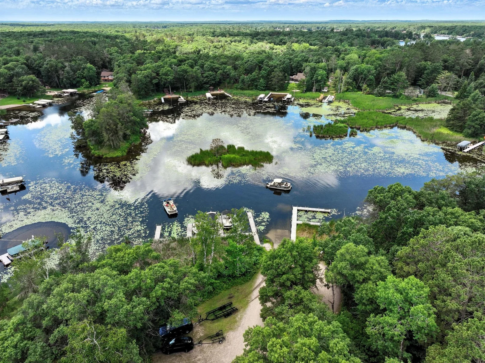 Beautiful aerial view of the protected bay, showcasing serene waters, docks, and boat activity nestled in nature.