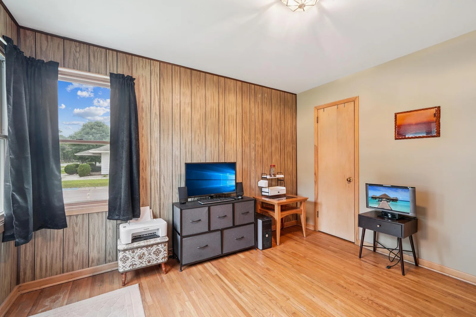 The second main floor bedroom features hardwood floors.