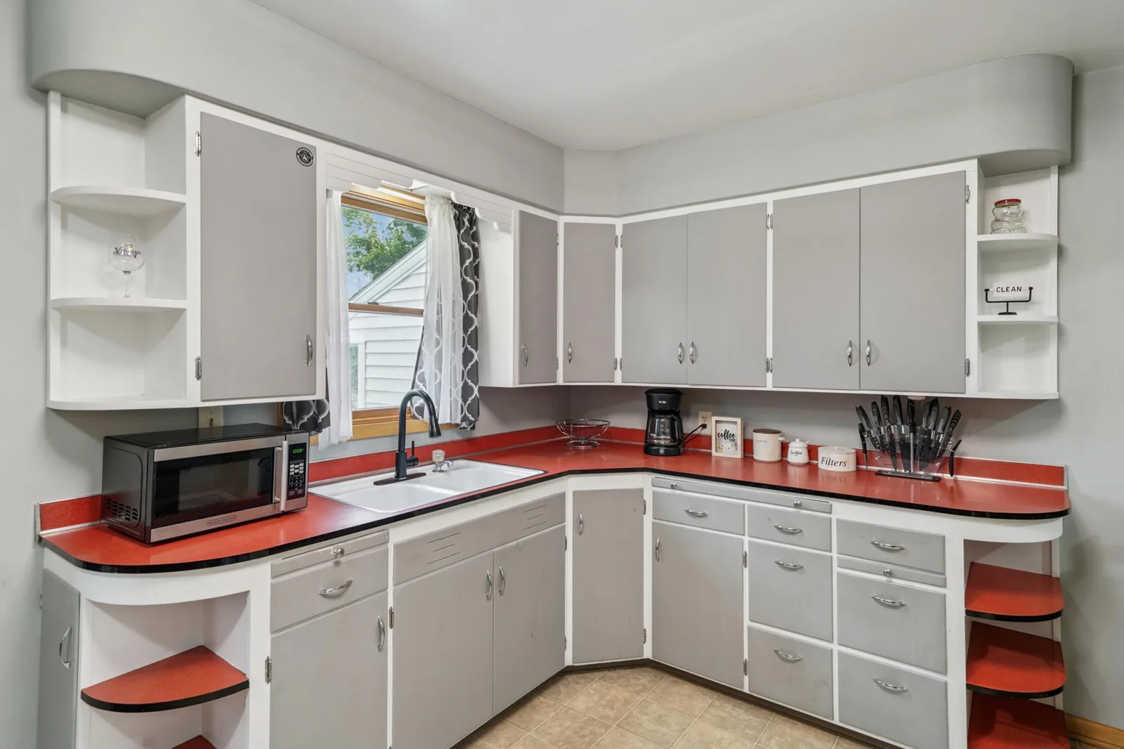 Kitchen features wood cabinets, easy to clean laminate countertops, and vinyl flooring.