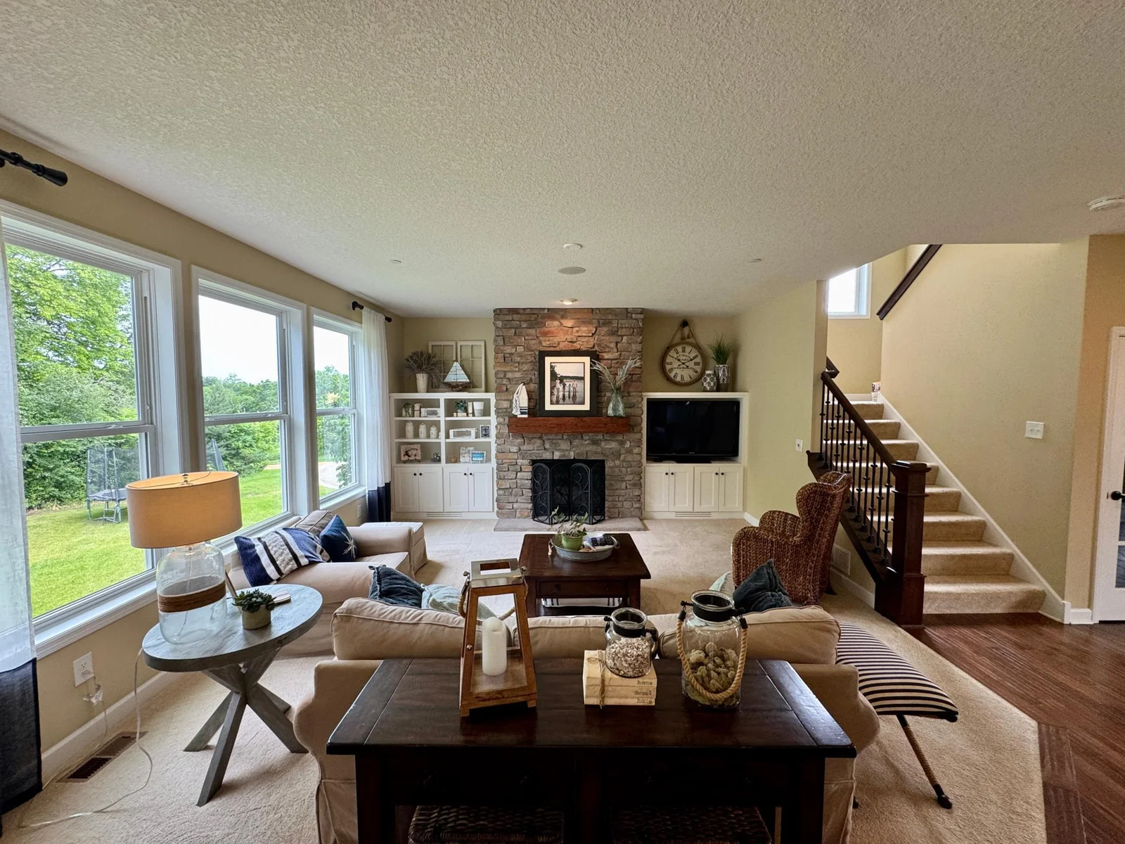 Custom upgrades throughout the house include floor to ceiling fireplace and surrounding built-ins.