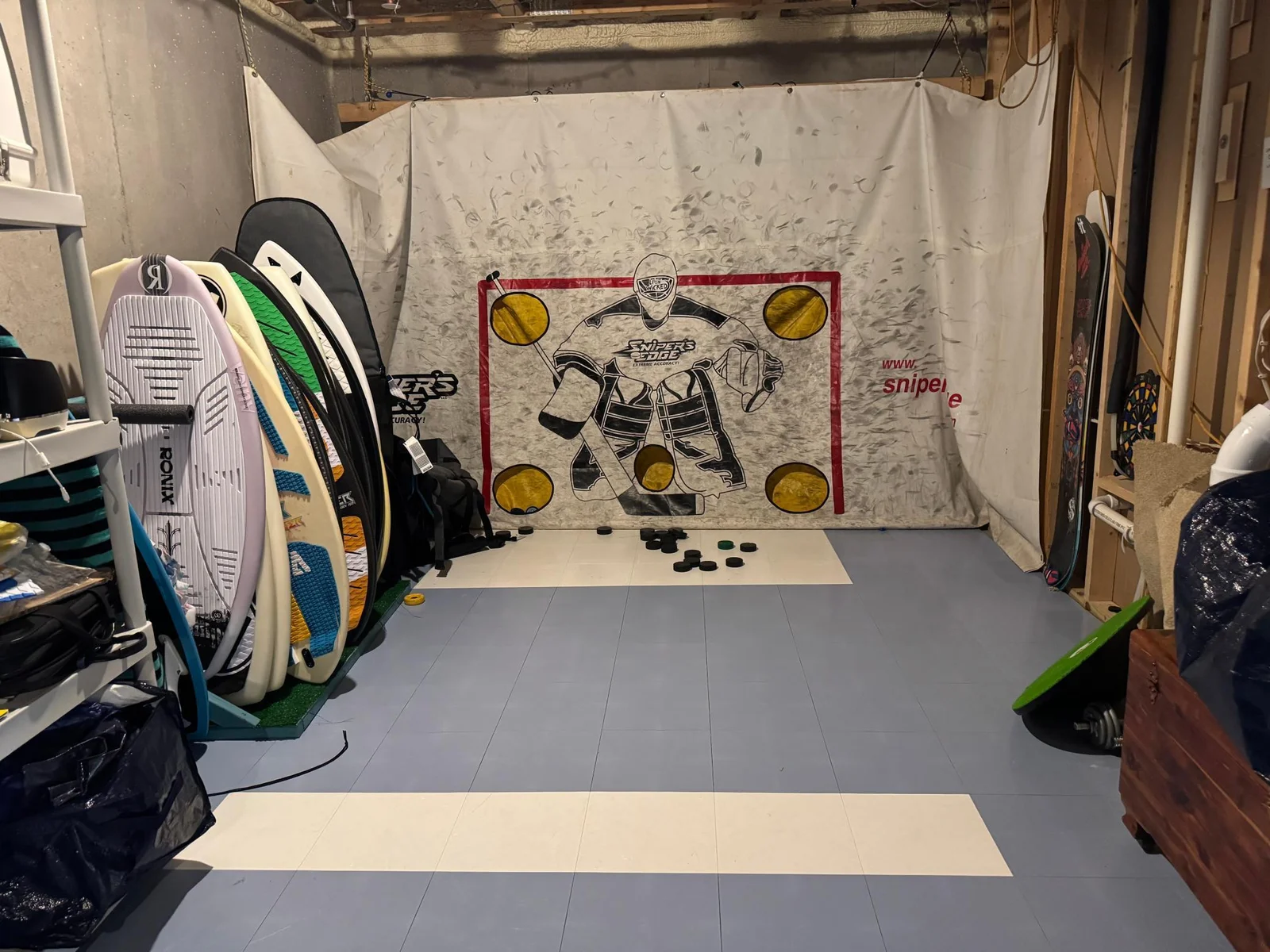 Because there are so many large closets and additional storage areas throughout the home, Mr. and Mrs. seller opted to turn this large lower level storage room into a hockey shooting room!