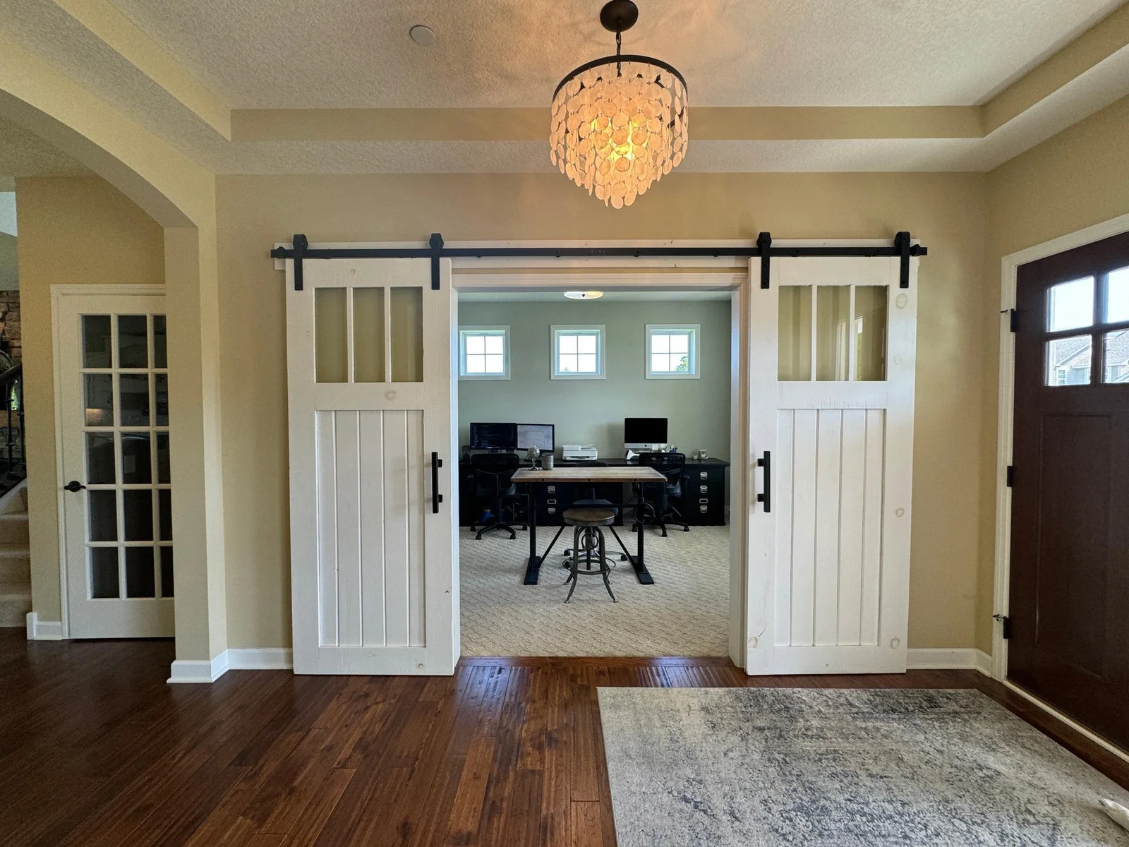 Custom barn doors lead you into the main floor office.
