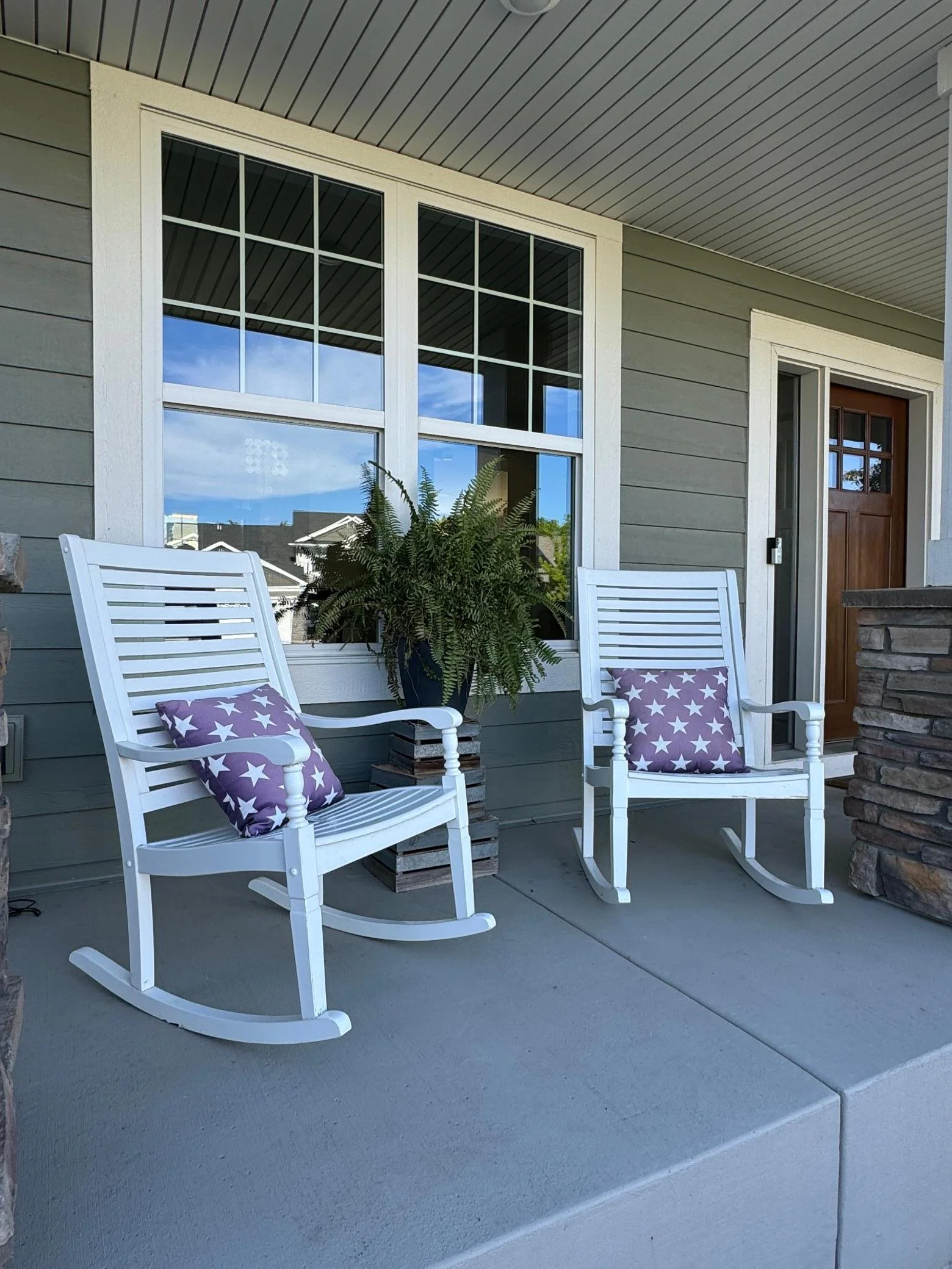 Large front porch extends across the whole front of the house.