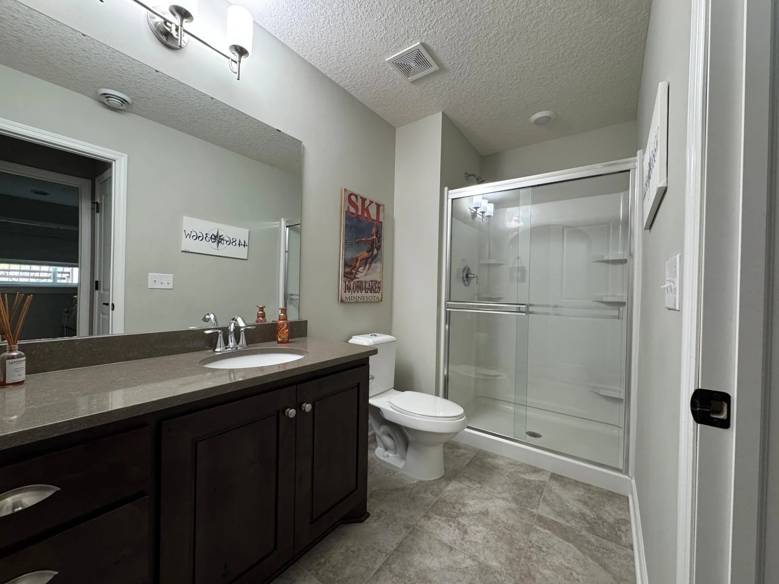 Guest will enjoy the lower level bathroom, appointed with a tile floor and upgraded vanity and counter top.