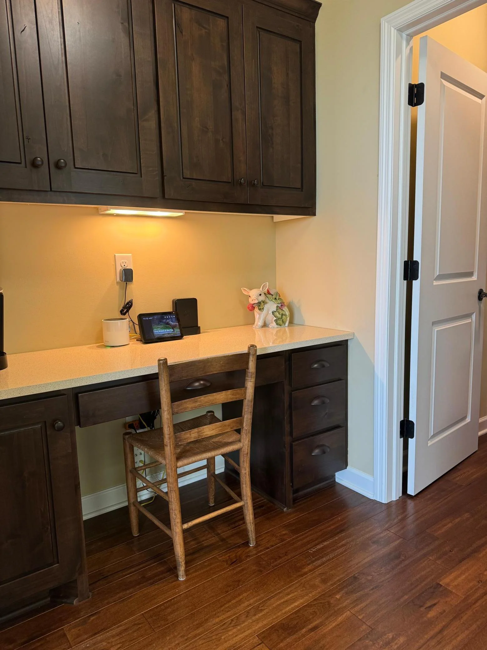 The kitchen tech center is the perfect place to hide all of the clutter that tends to collect in the kitchen and also makes a great beverage center.