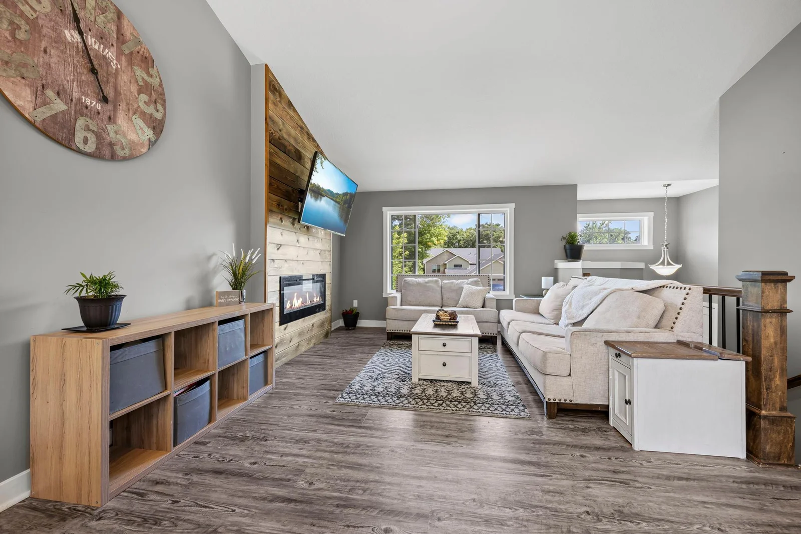Electric fireplace, plank flooring, natural lighting