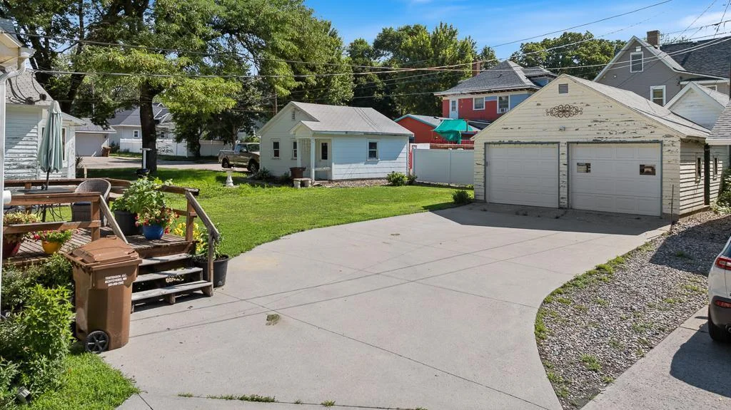 The concrete driveway leads all the way to the detached garage behind the home