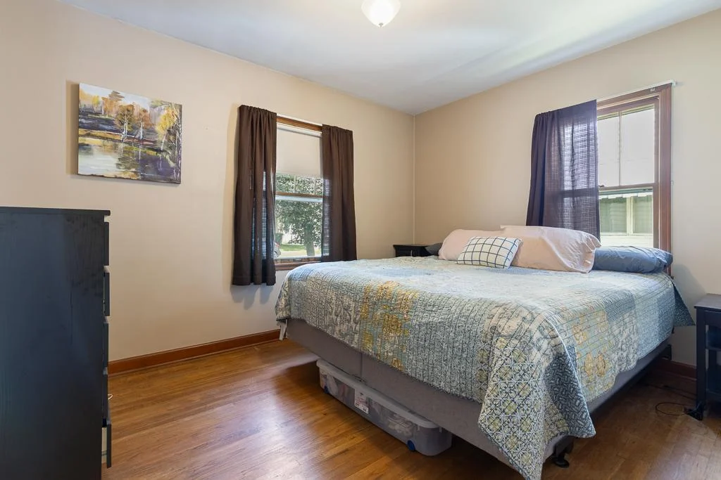 Primary bedroom features beautiful hardwood floors